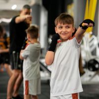 front-view-boy-training-gym_23-2150422461